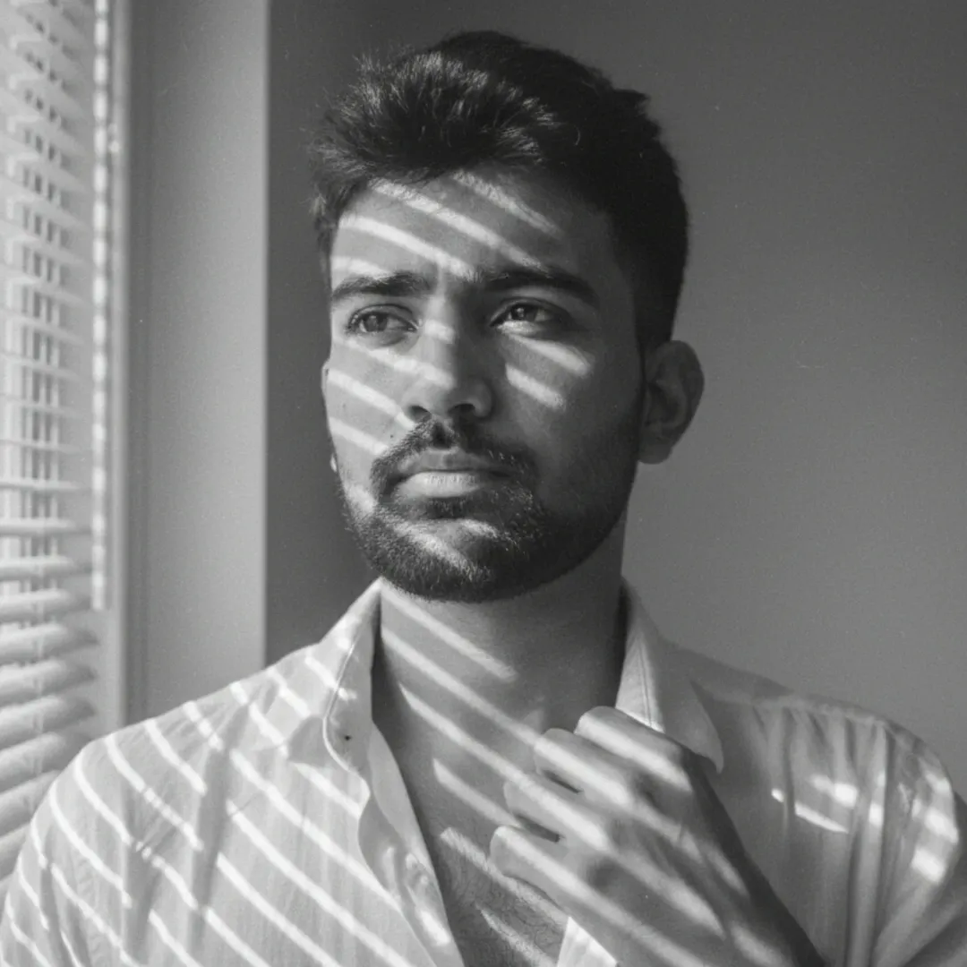 Monochrome portrait of Vikrant Chattha by a window